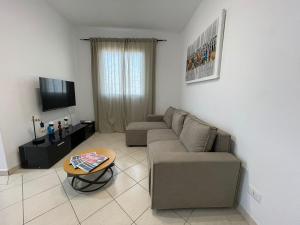 a living room with a couch and a table at Larriba Santa Maria by RPG Group in Santa Maria