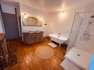 a bathroom with a tub and a sink and a shower at Grande maison Albuconis in Saint-Oradoux-près-Crocq +37 photos