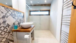 a bathroom with a bowl sink on a counter at The Cartshed in Llanvetherine +14 photos