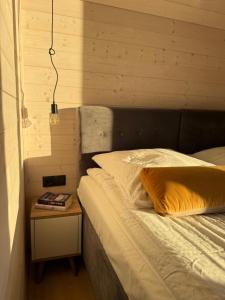 a bed in a room with a night stand next to a bed at Nowa Stodoła in Władysławowo
