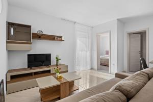 a living room with a couch and a tv at Apartment Lola in Peroj