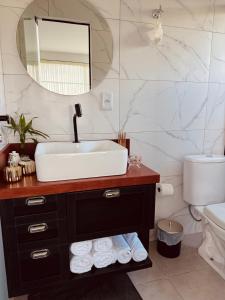 a bathroom with a sink and a mirror at Chalé Mirante dos Anjos in Rodeio +24 photos