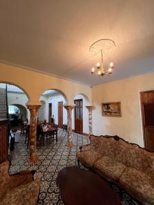 a living room with a couch and a chandelier at Posada La Pastora Colonial in Caracas