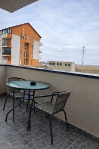 a table and a chair on a balcony at Hera Exclusive Stay 2 in Timişoara