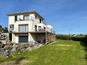 a large white house with a stone wall at Les Sternes in Telgruc-sur-Mer