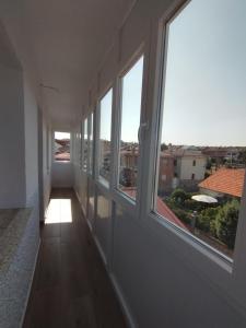 a hallway with windows and a view of a city at Alojamiento La Tortuga in Las Navas del Marqués