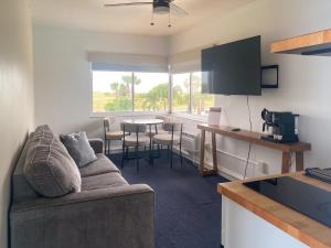 a living room with a couch and a table at Arvilla Resort in St. Pete Beach