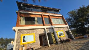 a building with yellow windows on top of it at Sunrise Inn in Yelagiri +20 photos