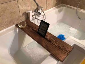 a laptop on a wooden board in a bath tub at Oligrae Cottage in Bridport +58 photos