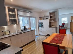 a large kitchen with a table and a dining room at Huus 8 in Westoverledingen