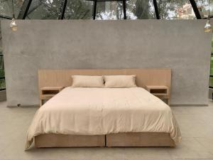 a bedroom with a large bed with two tables at Mineral Glamping Experience in Mineral del Chico