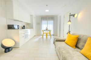 a living room with a couch and a table at Castell Beach Aparthotel in Castelldefels