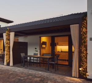 a patio with a table and a dining room at Villa Sawian in Appiano sulla Strada del Vino