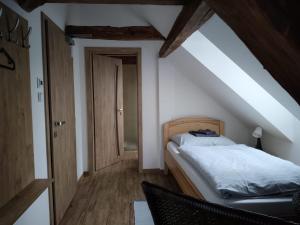 a bedroom with a bed in a attic at Penzion U Koruny in Ústí nad Labem