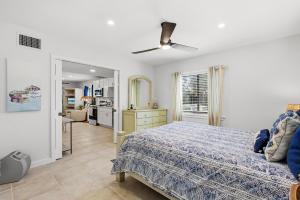 a bedroom with a bed with a blue comforter at Sea Dunes Nautilus B8 in New Smyrna Beach +48 photos