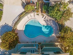 an overhead view of a swimming pool at a resort at Sea Dunes Nautilus B8 in New Smyrna Beach