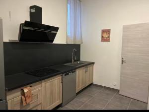 a kitchen with a sink and a counter top at Chez aurelie in Agnin +4 photos