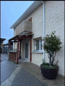 a building with a tree in front of it at Chez aurelie in Agnin