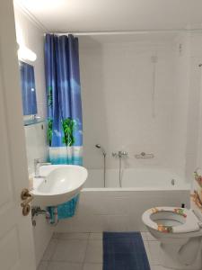 a bathroom with a sink and a toilet and a tub at Alkyona in Patra +10 photos