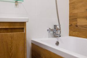 a bathroom sink with a faucet on top of it at Center 2 poverh Ecoflow VIP TopApart in Sumy