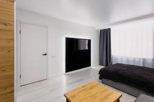 a bedroom with a bed and a flat screen tv at Center 2 poverh Ecoflow VIP TopApart in Sumy