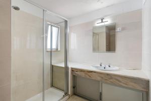 a bathroom with a sink and a shower at El Shaddai 3 in Atalaia