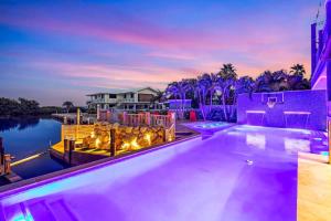 a house with a swimming pool with purple lighting at Bumpa's Big House in Marathon
