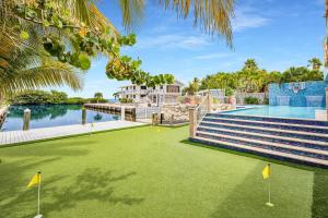 a golf course with a view of the water at Bumpa's Big House in Marathon