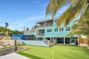 a large blue house with a green yard at Bumpa's Big House in Marathon +73 photos