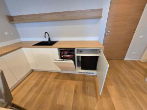 a kitchen with a sink and a counter at Apart HOTEL VOGH OLIMP - S605 in Văleni