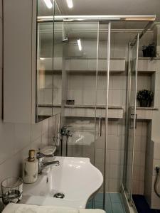 a bathroom with a sink and a glass shower at Vallia Suites - Double suite B1 in Nafpaktos +12 photos
