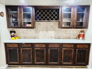 a kitchen counter with wooden cabinets and teddy bears at Complete Home with everything in The Colony +21 photos