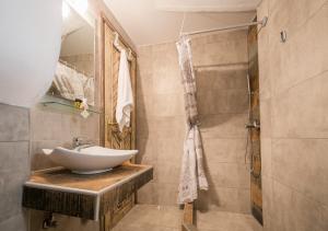 a bathroom with a sink and a shower at Agali Villa in Limenaria