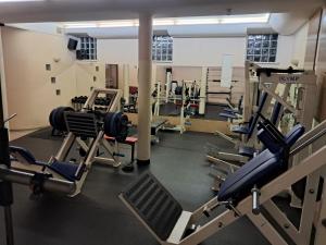 a gym with rows of treadmills and machines at Hotel Maggi in Rogoźno