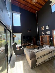 a large living room with a couch and a chair at Sol de campo in Santa Clara del Mar +54 photos