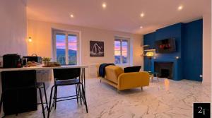 a living room with a yellow chair and a kitchen at LE 21 - Suite SPA Premium - Jacuzzi Privatif & Vue Rhône in Vienne