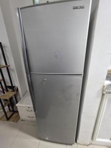 a stainless steel refrigerator in a room at Apartment condo in Ajman in Ajman 