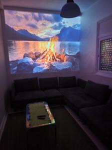 a living room with a fire mural on the wall at your cute house in Salé