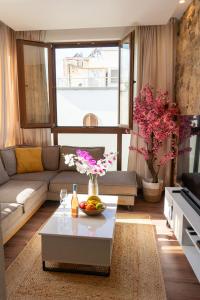 a living room with a couch and a table at Kos View City , Luxury Old Town in Kos