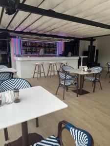 a restaurant with tables and chairs and a bar at Wyndham studio 2205 in Surin Beach