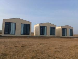 a row of modular homes in a field at Aydarkul Beach in Taldy