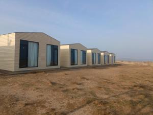 a row of modular homes in a field at Aydarkul Beach in Taldy +17 photos