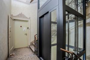 a hallway with a glass door and a staircase at Casa Esvael - Historic Rooms in Verona City Center in Verona
