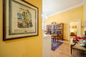 a living room with a painting hanging on a wall at Casa Esvael - Historic Rooms in Verona City Center in Verona