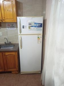 a white refrigerator in a kitchen with a sink at Los eucaliptos in Andino