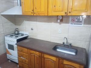 a kitchen with a sink and a stove at Los eucaliptos in Andino +28 photos