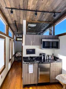 a kitchen with a stove top oven in a room at NEW! Modern Cabin Tiny Home at Cliffside #1 in Orderville