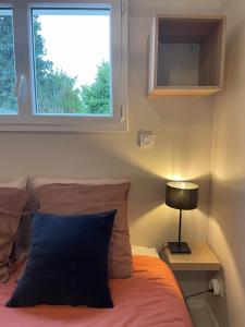 a bedroom with a bed and a window at Chez Sophie in Orléans