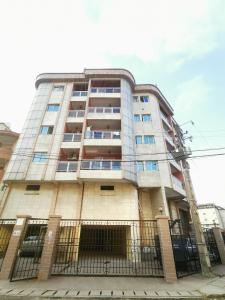 a tall building with a fence in front of it at Studio VIP - Bonamoussadi - Groupe électrogène - 2douches in Douala