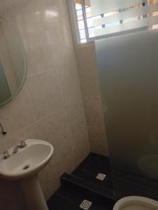 a bathroom with a sink and a toilet and a window at Valdez Resi in Santa Rosa +3 photos